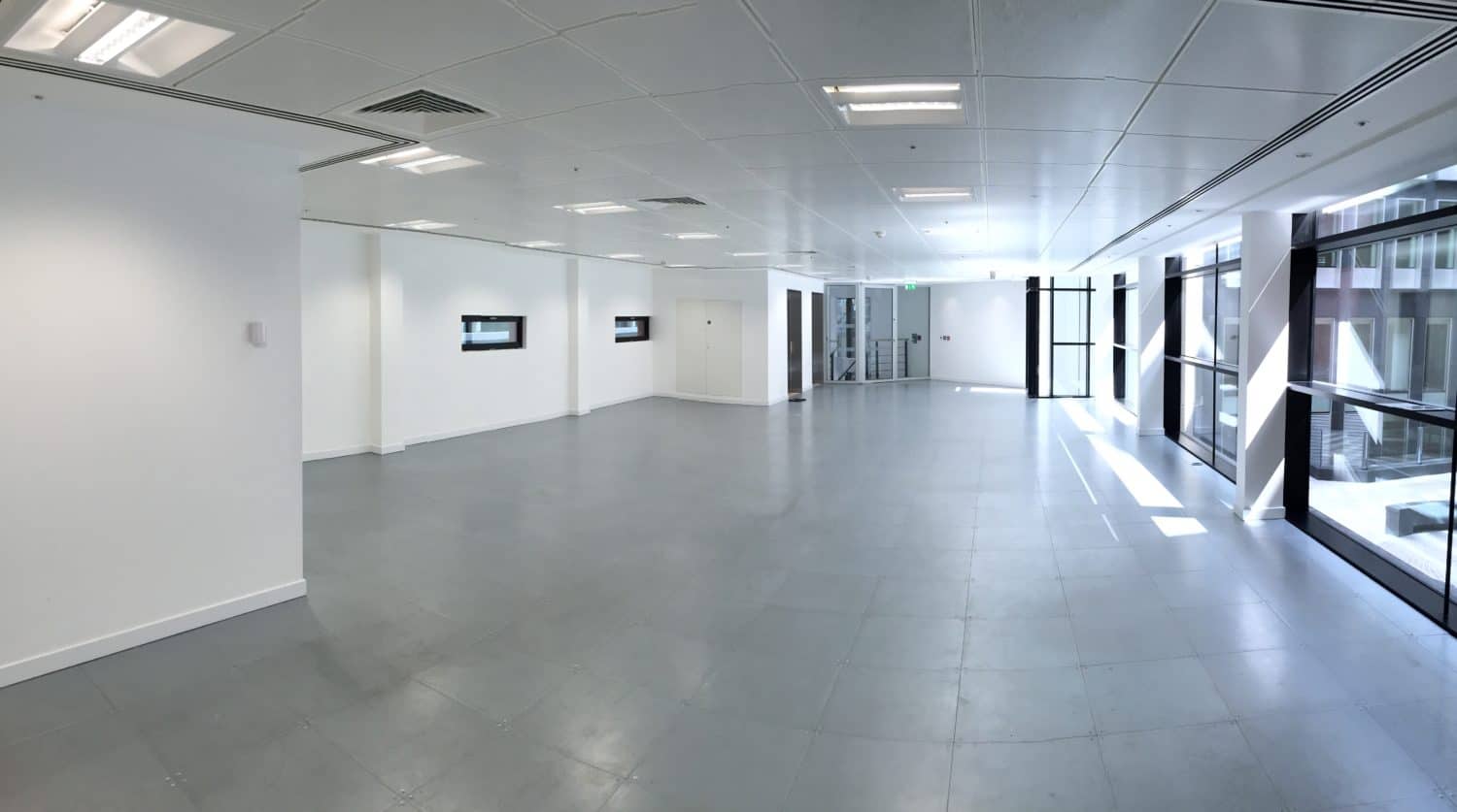 Empty office space with large windows